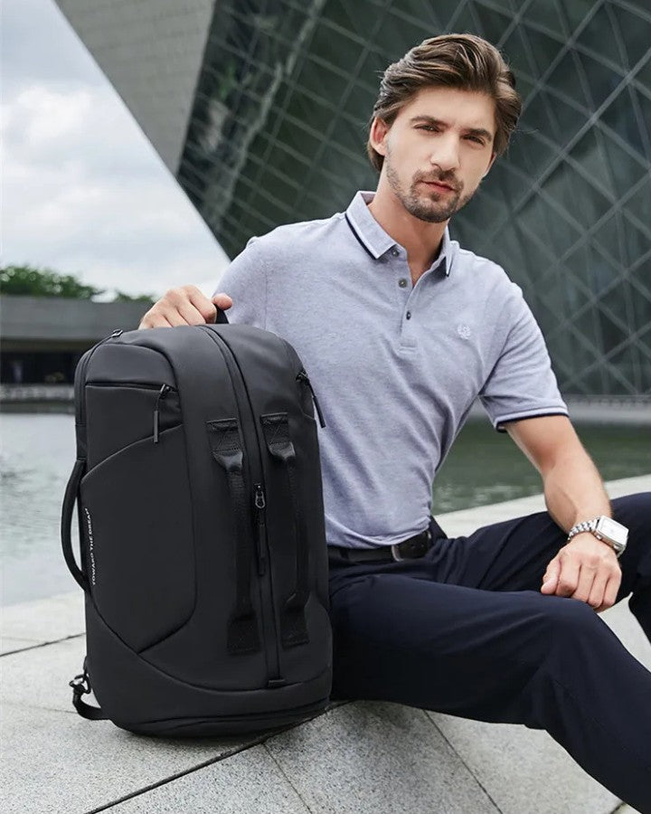 Sac à Dos Multi Usage, noir, posé à côté d'un homme élégant